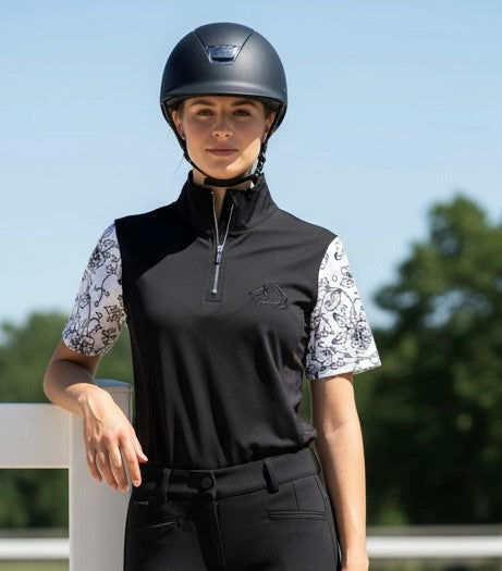 Women's black Midnight Floral Quarter-Zip riding shirt, intricate white floral sleeves, breathable mesh panels under arms, moisture-wicking fabric, and quarter-zip closure for equestrian comfort and style by PK Equine