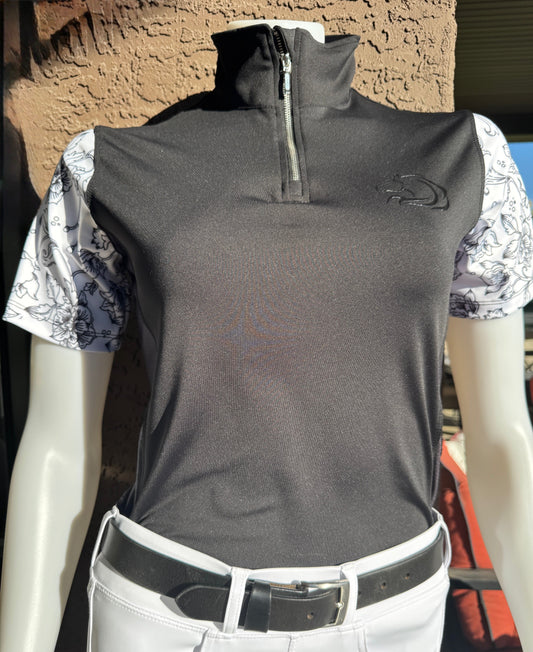 Women's black Midnight Floral Quarter-Zip riding shirt, intricate white floral sleeves, breathable mesh panels under arms, moisture-wicking fabric, and quarter-zip closure for equestrian comfort and style by PK Equine