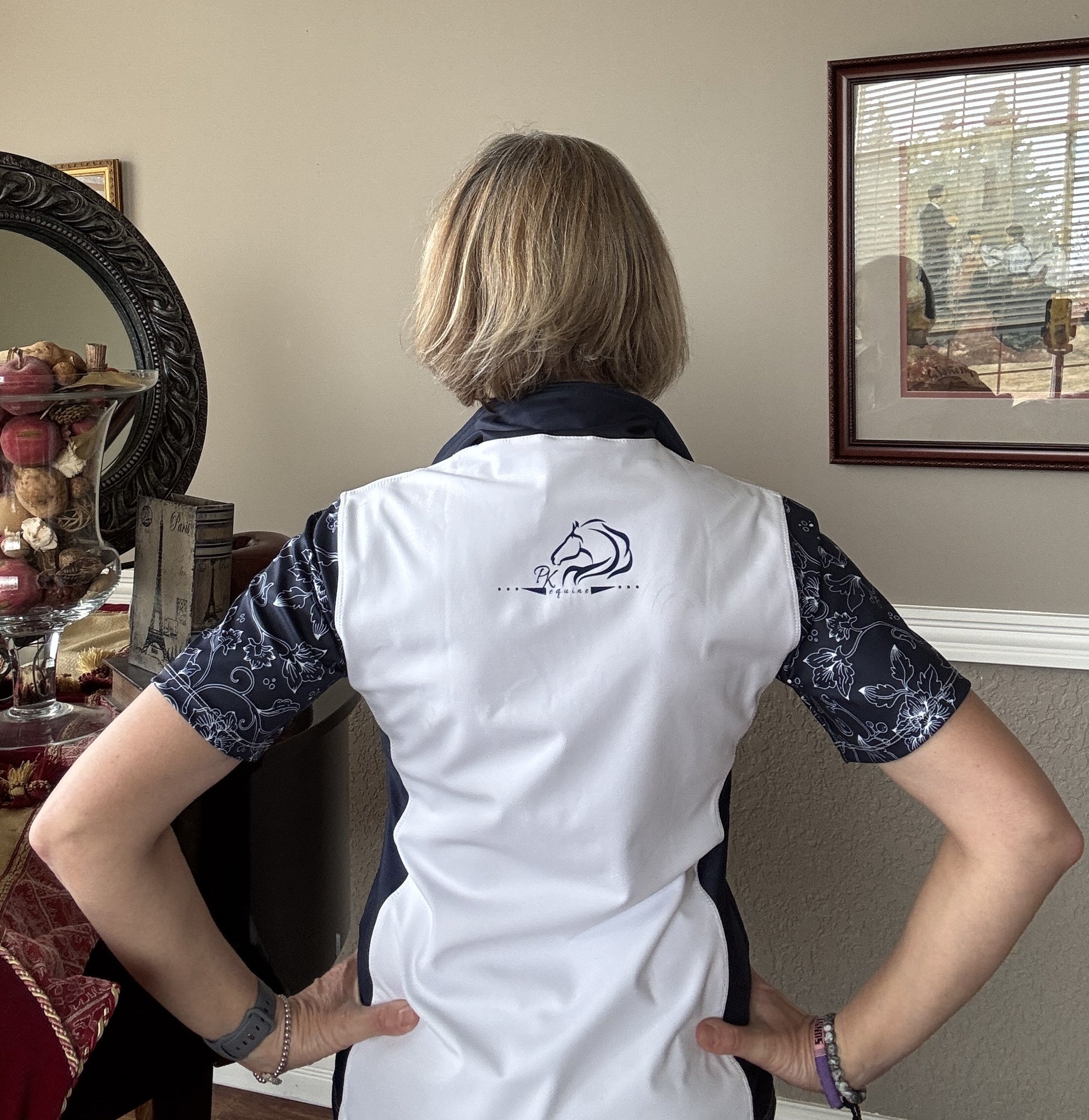 Women’s floral half-zip riding top in breathable, stretchy fabric with floral sleeves by PK Equine