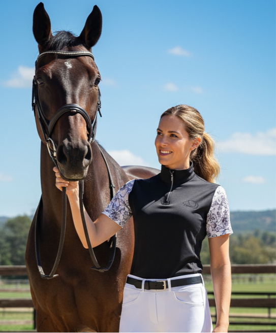 Women's black Midnight Floral Quarter-Zip riding shirt, intricate white floral sleeves, breathable mesh panels under arms, moisture-wicking fabric, and quarter-zip closure for equestrian comfort and style by PK Equine