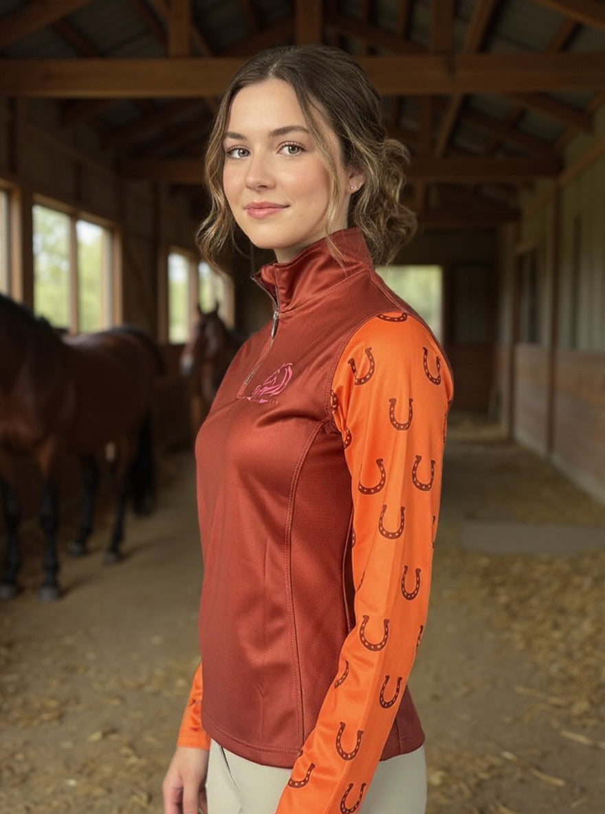 Women’s breathable mesh riding top with stretchy fabric by PK Equine. Long sleeve orange and brown horseshoe riding top