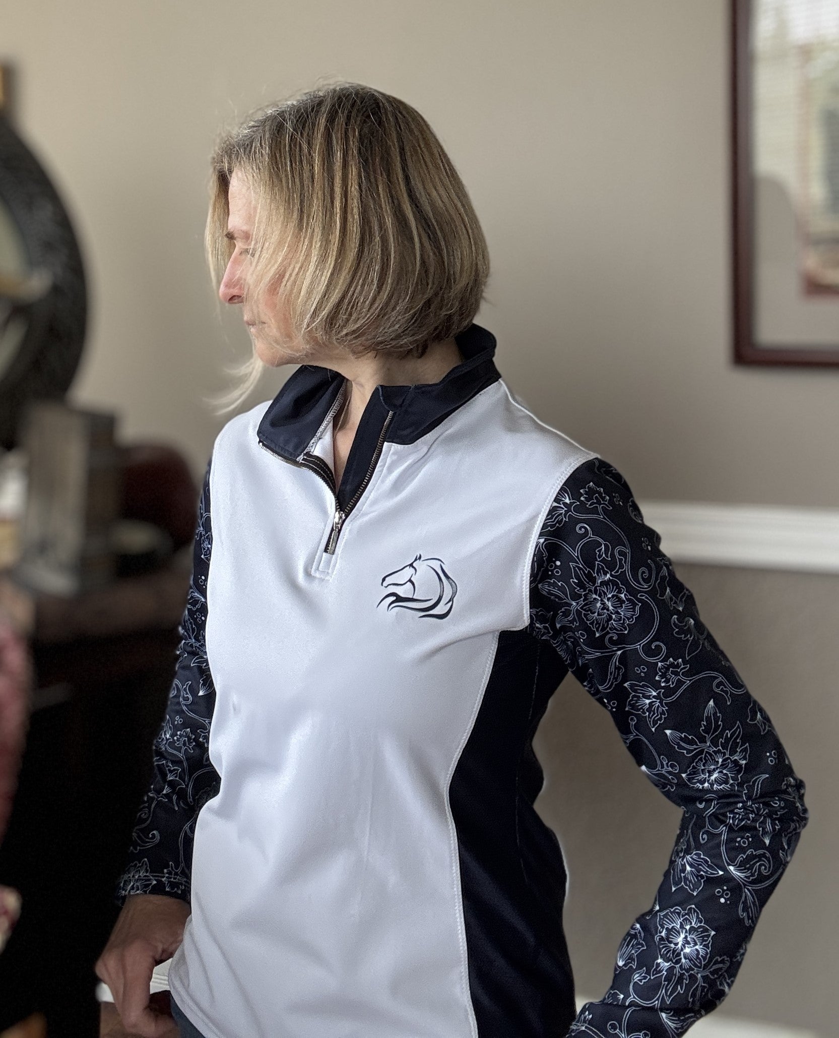 Women’s floral half-zip riding top in breathable, stretchy fabric with floral sleeves by PK Equine