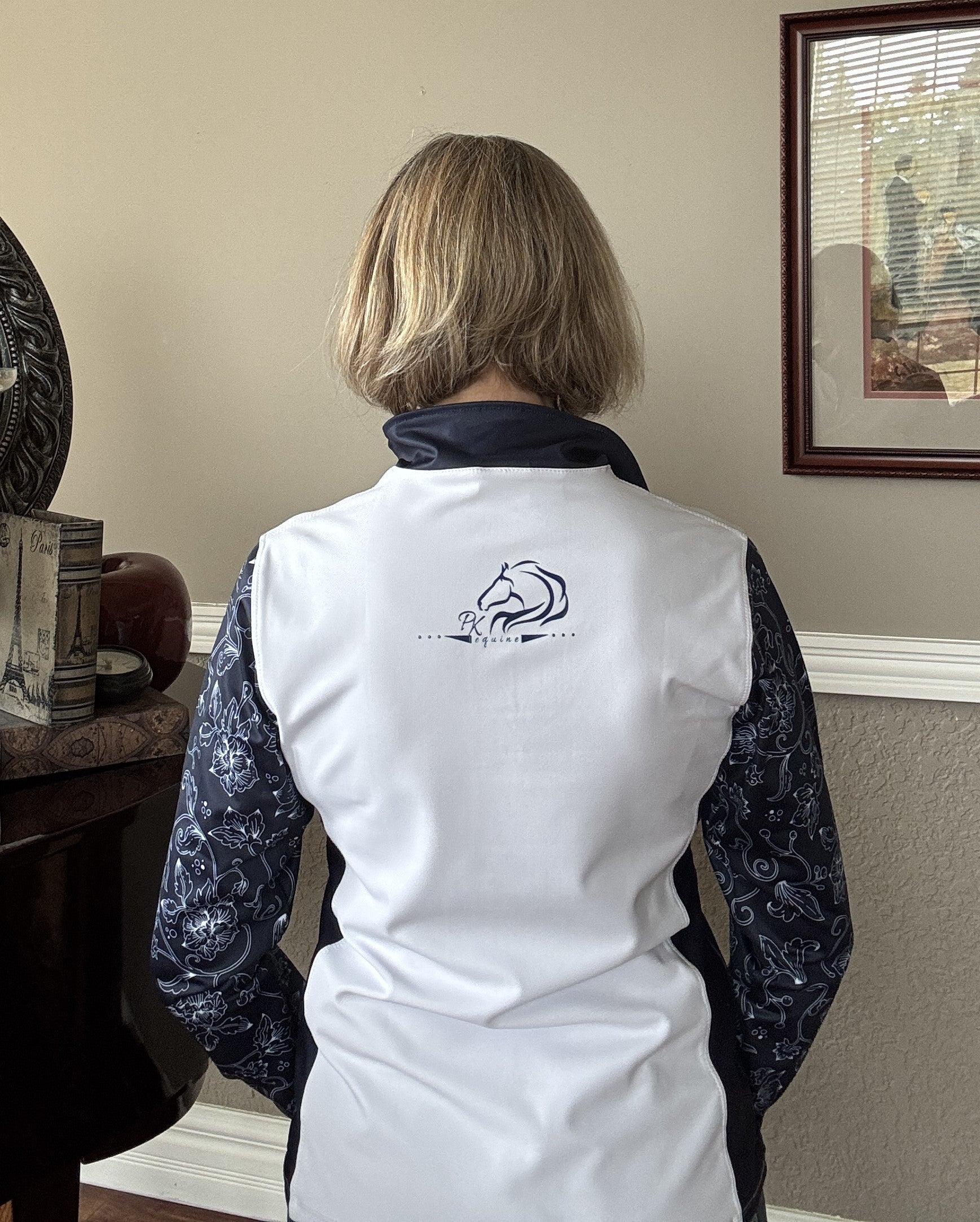 Women’s floral half-zip riding top in breathable, stretchy fabric with floral sleeves by PK Equine